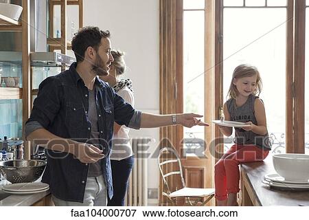 Family setting table for dinner View Large Photo Image Stock Photo - Family setting table for dinner. Fotosearch