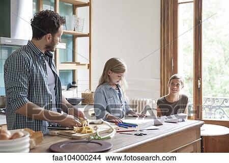 Picture - Family spending time together in kitchen. Fotosearch