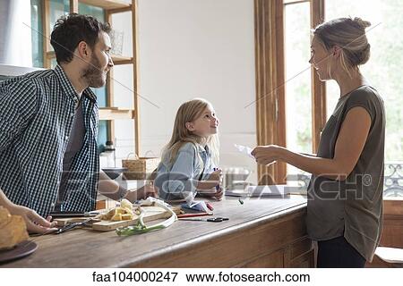 Stock Photo - Family spending time together in kitchen. Fotosearch