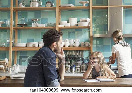 Stock Photo - Family together in kitchen. Fotosearch