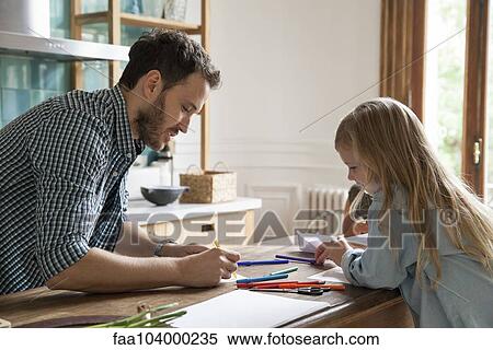 Stock Photography - Father and daughter drawing at home. Fotosearch