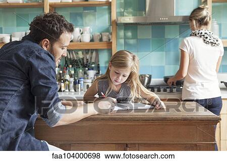 Stock Photo - Father helping daughter practice writing. Fotosearch