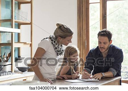 Father helping young daughter with her lessons View Large Photo Image Picture - Father helping young daughter with her lessons. Fotosearch