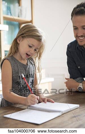 Father watching young daugther practice writing View Large Photo Image Stock Photograph - Father watching young daugther practice writing. Fotosearch