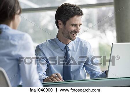 Stock Image - Financial advisor meeting with prospective customer. Fotosearch
