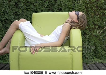 Girl napping on armchair outdoors View Large Photo Image Stock Photography - Girl napping on armchair outdoors. Fotosearch