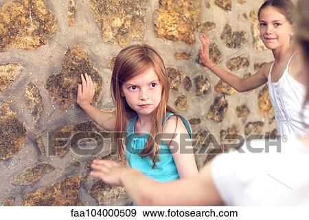 Girls leaning against wall during game of tag View Large Photo Image Stock Photo - Girls leaning against wall during game of tag. Fotosearch