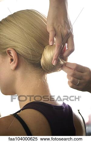 Hairdresser arranging woman's hair in a chignon, cropped View Large Photo Image Stock Photography - Hairdresser arranging woman's hair in a chignon, cropped. Fotosearch