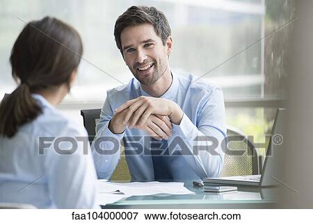 Stock Photo - Insurance agent meeting with prospective customer. Fotosearch