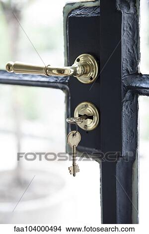 Picture - Key in door lock, close-up. Fotosearch