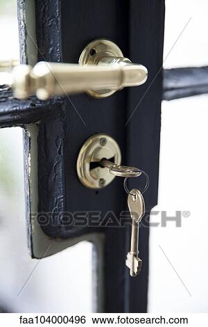 Stock Photograph - Key in door lock, close-up. Fotosearch