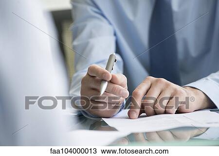 Stock Image - Lawyer reviewing document with client. Fotosearch