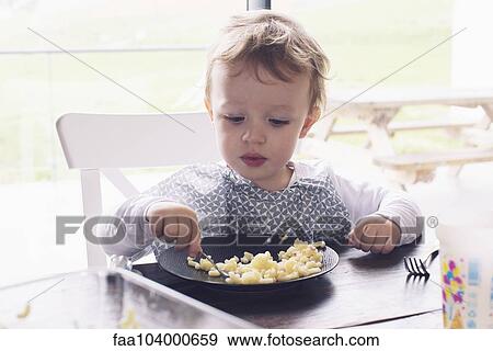 Little boy eating macaroni View Large Photo Image Stock Photo - Little boy eating macaroni. Fotosearch