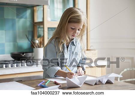 Little girl coloring in kitchen View Large Photo Image Stock Photo - Little girl coloring in kitchen. Fotosearch