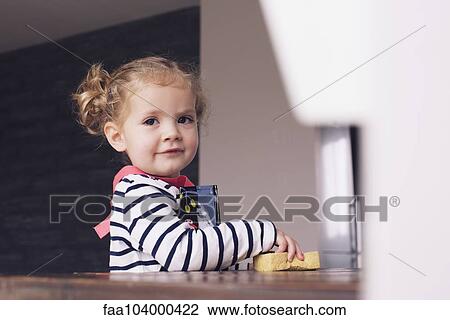 Little girl helping with housework, portrait View Large Photo Image Stock Image - Little girl helping with housework, portrait. Fotosearch