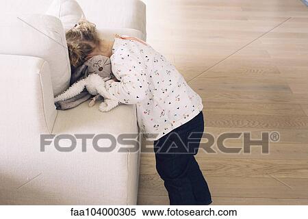 Little girl hiding her face in sofa cushions View Large Photo Image Stock Photography - Little girl hiding her face in sofa cushions. Fotosearch