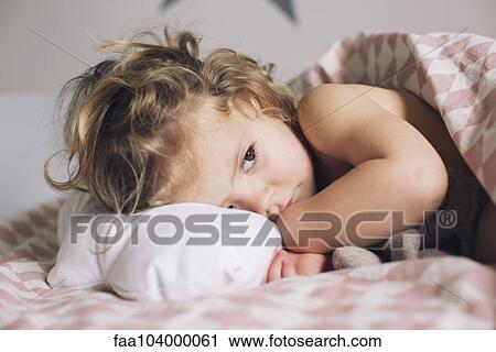 Little girl lying down for a nap View Large Photo Image Stock Image - Little girl lying down for a nap. Fotosearch