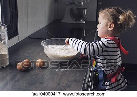 Little girl mixing batter View Large Photo Image Stock Photo - Little girl mixing batter. Fotosearch