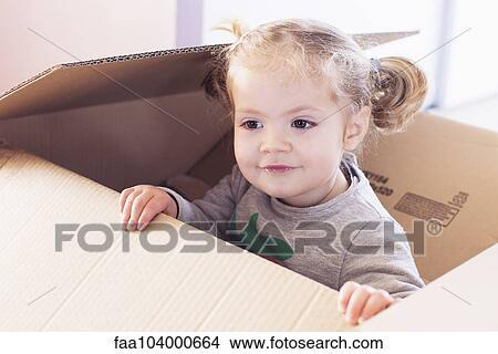 Picture - Little girl playing in cardboard box. Fotosearch