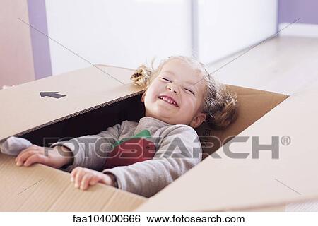 Little girl playing in cardboard box, portrait View Large Photo Image Stock Photograph - Little girl playing in cardboard box, portrait. Fotosearch