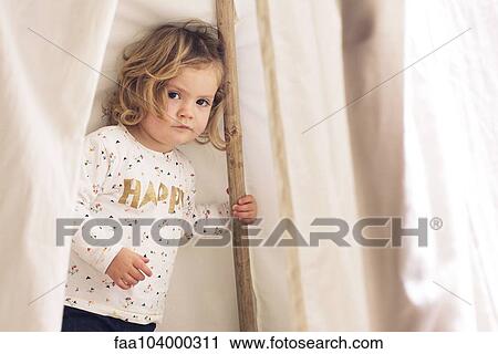 Little girl playing in tent, portrait View Large Photo Image Stock Image - Little girl playing in tent, portrait. Fotosearch