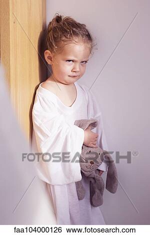 Stock Photograph - Little girl sulking in corner. Fotosearch