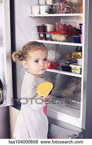 Little girl taking food out of refrigerator View Large Photo Image Stock Photo - Little girl taking food out of refrigerator. Fotosearch
