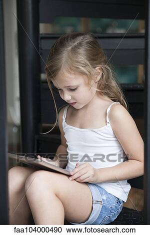 Little girl using digital tablet View Large Photo Image Stock Image - Little girl using digital tablet. Fotosearch