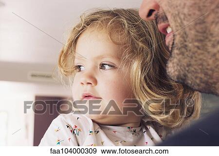 Little girl with father, looking away in interest View Large Photo Image Stock Photo - Little girl with father, looking away in interest. Fotosearch