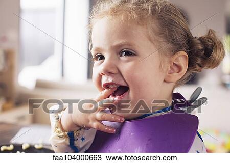 Little girl with fingers in mouth View Large Photo Image Stock Image - Little girl with fingers in mouth. Fotosearch