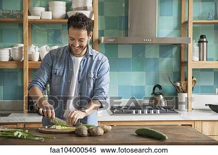 Man chopping up fresh ingredients in kitchen View Large Photo Image Stock Photography - Man chopping up fresh ingredients in kitchen. Fotosearch