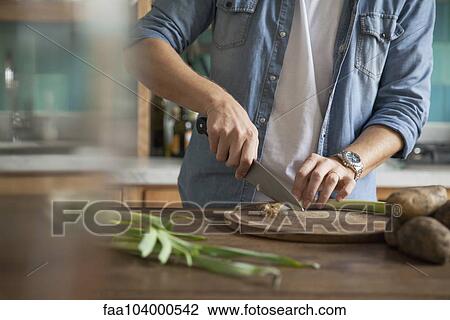 Man cutting spring onion View Large Photo Image Stock Image - Man cutting spring onion. Fotosearch