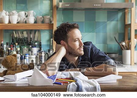 Stock Photo - Man daydreaming in kitchen. Fotosearch