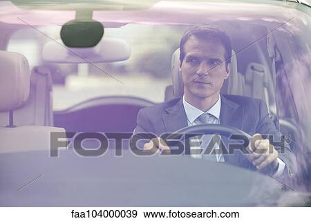Stock Photo - Man driving car without passengers. Fotosearch