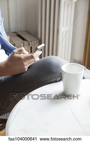 Stock Image - Man using cell phone. Fotosearch
