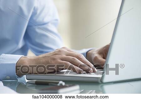 Stock Photo - Man using laptop computer. Fotosearch