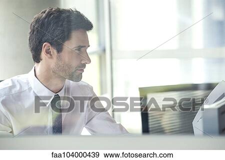 Office worker at work in cubicle View Large Photo Image Stock Photo - Office worker at work in cubicle. Fotosearch