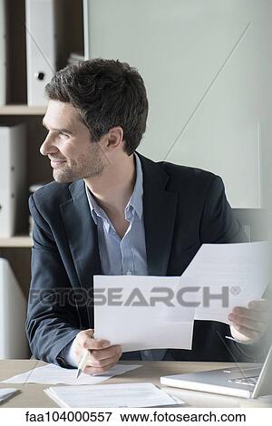 Stock Photo - Office worker bored with paperwork. Fotosearch