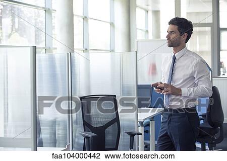 Office worker on break looking out window View Large Photo Image Stock Image - Office worker on break looking out window. Fotosearch