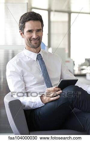 Stock Image - Office worker using digital tablet. Fotosearch