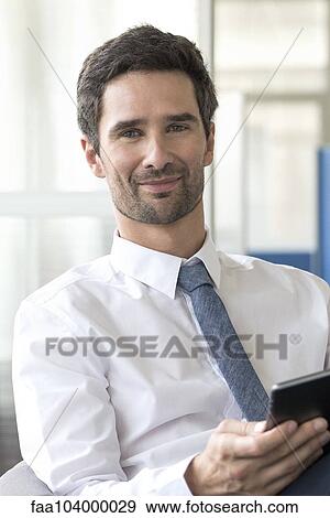 Stock Photo - Office worker using digital tablet. Fotosearch