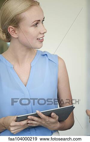 Stock Photo - Office worker with digital tablet. Fotosearch