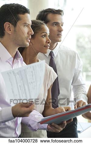 Stock Photo - Office workers paying attention at meeting. Fotosearch