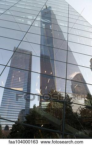 Stock Image - One World Trade Center reflected on building facade, Manhattan, New York City, New York, USA. Fotosearch