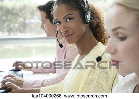 Stock Photograph - Operator in call center, portrait. Fotosearch