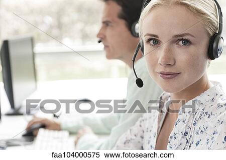 Stock Photography - Operator in call center, portrait. Fotosearch