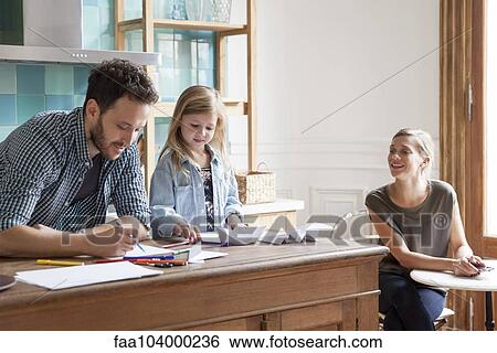 Parents spending time with young daughter at home View Large Photo Image Stock Photograph - Parents spending time with young daughter at home. Fotosearch