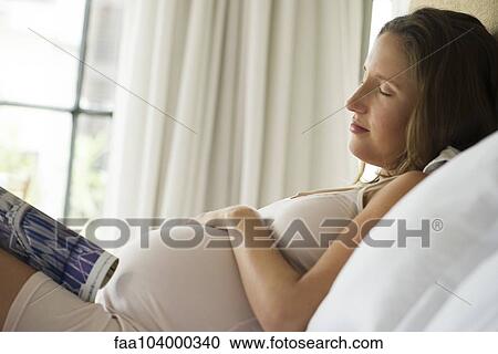 Stock Image - Pregnant woman napping. Fotosearch