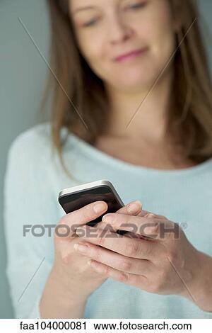Stock Image - Smartphones help friends stay connected. Fotosearch