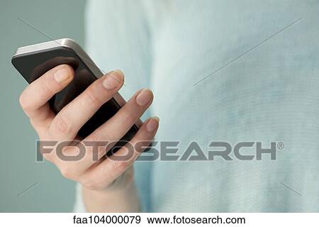 Stock Photo - Smartphones make staying in touch with friends easy. Fotosearch